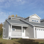 Main entrance of 1448 Mountain View Road in Williston Vermont with 2 car garage on sunny day