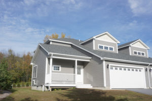 Main entrance of 1448 Mountain View Road in Williston Vermont with 2 car garage on sunny day